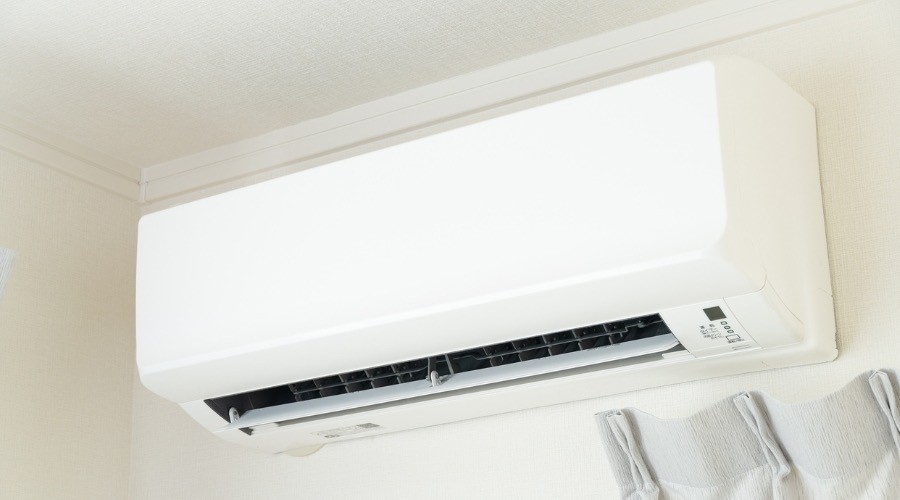 Ductless mini split air conditioner mounted on a wall, illustrating efficient cooling solution for homes.
